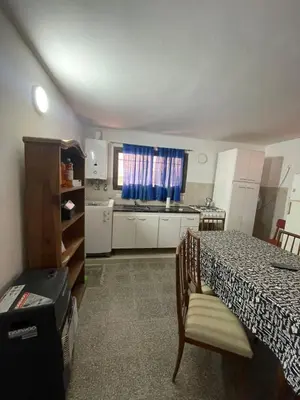 a room with a table and a kitchen with a table and chairs at casita Playas de oro in Villa Carlos Paz
