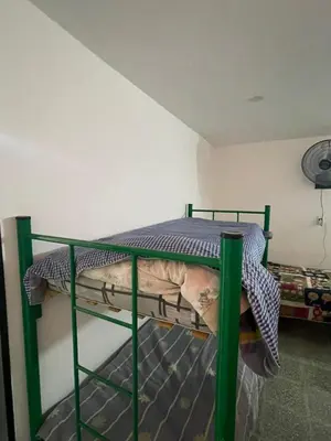 a small green bunk bed in a room at casita Playas de oro in Villa Carlos Paz