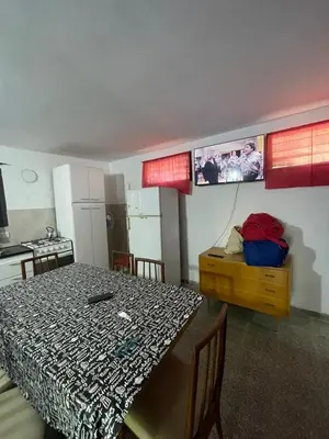 a dining room with a table and a kitchen at casita Playas de oro in Villa Carlos Paz