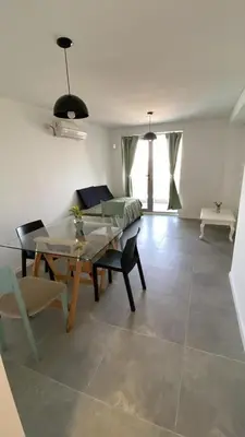 a living room with a table and a couch at Departamento 1 dor ciudad gama seguridad 24h pileta calidad in Cordoba