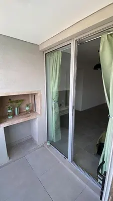 a room with a sliding glass door in a room at Departamento 1 dor ciudad gama seguridad 24h pileta calidad in Cordoba