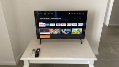 a tv sitting on a table with a remote control at Departamento 1 dor ciudad gama seguridad 24h pileta calidad in Cordoba
