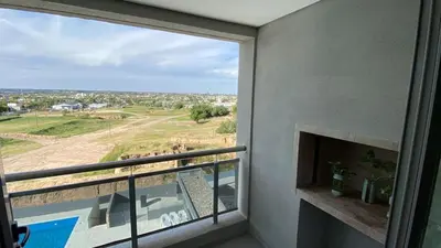 a balcony with a fireplace and a view of a yard at Departamento 1 dor ciudad gama seguridad 24h pileta calidad in Cordoba