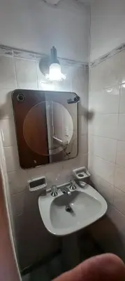 a bathroom with a sink and a mirror at Malvinas Departamento in Villa Carlos Paz