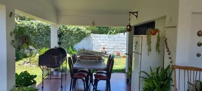 a patio with a table and a refrigerator at Malvinas Departamento in Villa Carlos Paz
