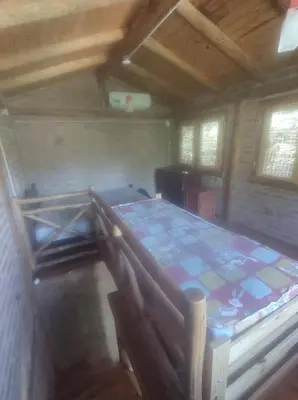 a bedroom with a bed in a room at Cabañas L' armonie in Bialet Massé