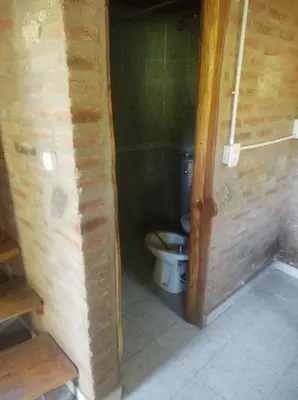 a small bathroom with a toilet in a room at Cabañas L' armonie in Bialet Massé