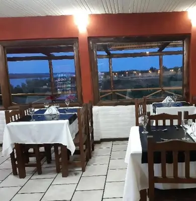 a restaurant with two tables and two windows at Posada Miralejos in Trapiche