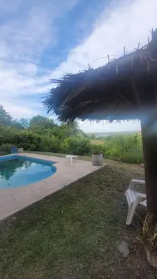 a view of a pool with a table and a bench at Posada Miralejos in Trapiche
