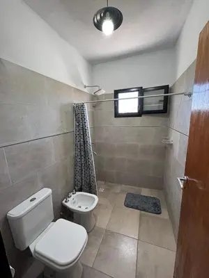 a bathroom with a toilet and a shower at Cabaña Valle del alma in Nono