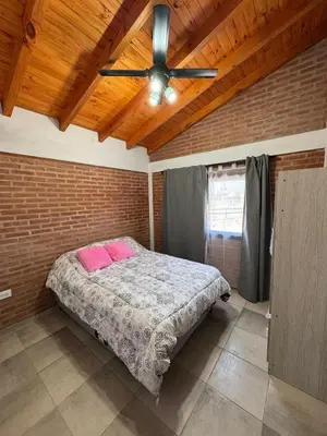 a bedroom with a bed and a ceiling fan at Cabaña Valle del alma in Nono