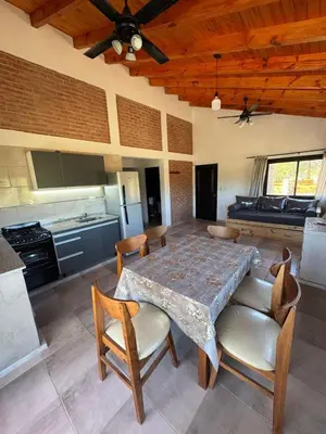 a kitchen with a table and chairs in a room at Cabaña Valle del alma in Nono