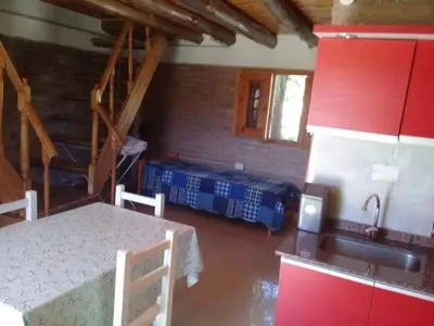 a kitchen with a table and a sink in a room at La Fortaleza in Villa Parque Siquiman