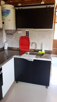 a kitchen with a sink and a red bag on the counter at La Fortaleza in Villa Parque Siquiman