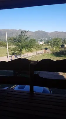 a person laying on a bed looking out a window at La Fortaleza in Villa Parque Siquiman