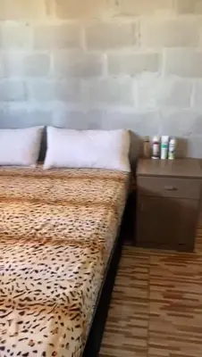 a bedroom with a leopard print bed and a nightstand at Dulce Azul in Villa García