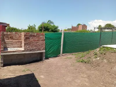 a fence with a green tarp on top of it at Dulce Azul in Villa García