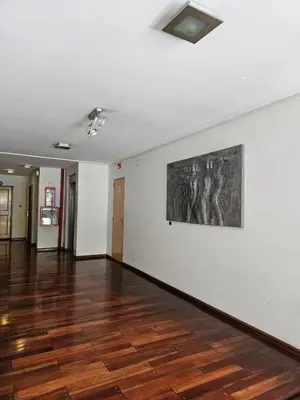 a room with a painting on the wall and a wooden floor at Moderno departamento con terraza privada in Cordoba