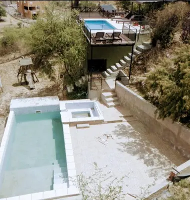 an overhead view of a swimming pool in a yard at Cabañas La Puesta del Sol in Estancia Vieja