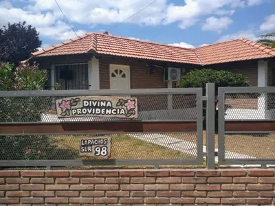 a house with a sign on a fence at Divina providencia in Merlo