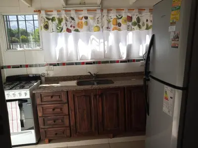 a kitchen with a sink and a refrigerator at Divina providencia in Merlo