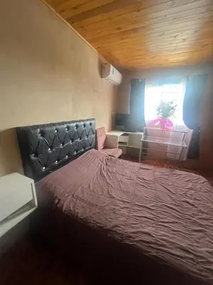 a bedroom with a large bed with a red blanket at La casa accesible y perfecta para tus vacaciones in Villa Santa Cruz del Lago