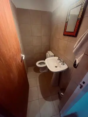 a small bathroom with a toilet and a sink at La casa accesible y perfecta para tus vacaciones in Villa Santa Cruz del Lago