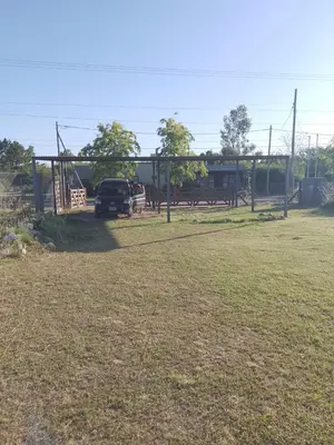 a parking lot with a truck parked in a field at Sol y Calma in Villa Rumipal