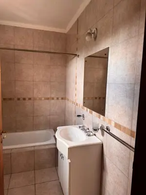 a bathroom with a sink and a tub and a mirror at Complejo EbenEzer in Merlo
