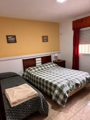 a bedroom with two beds and a window at Complejo EbenEzer in Merlo