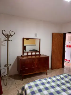 a bedroom with a dresser with a mirror on it at Complejo EbenEzer in Merlo