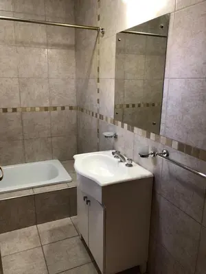 a bathroom with a sink and a tub and a mirror at Complejo EbenEzer in Merlo