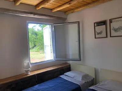 a bedroom with a large window and a bed at Casa Titi in Arroyo de Los Patos