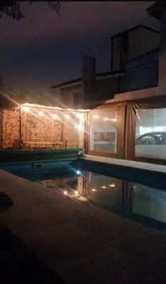 a house with a swimming pool at night at Exclusiva cabaña in Villa Santa Cruz del Lago