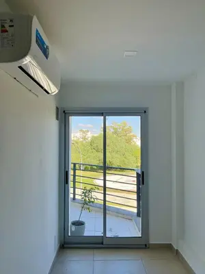 an empty room with a door to a balcony at Departamento en General Paz I in Cordoba