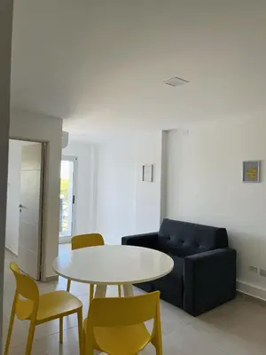 a living room with a table and chairs and a couch at Departamento en General Paz I in Cordoba