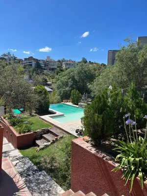 a view of a swimming pool from a house at Rincón Villa del Lago in Villa Carlos Paz