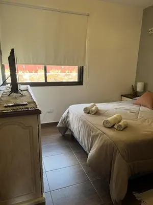 a bedroom with a bed with two towels on it at Rincón Villa del Lago in Villa Carlos Paz