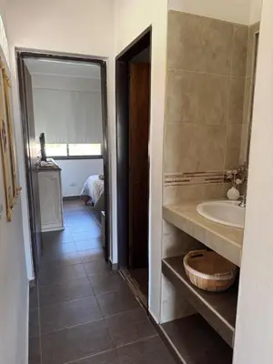 a bathroom with a sink and a tub and a mirror at Rincón Villa del Lago in Villa Carlos Paz
