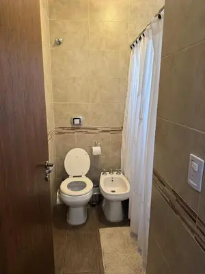 a small bathroom with a toilet and a sink at Rincón Villa del Lago in Villa Carlos Paz