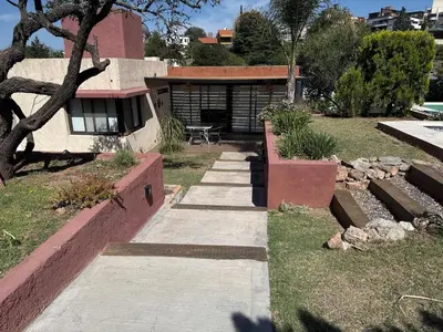 a house with a walkway in front of it at Rincón Villa del Lago in Villa Carlos Paz