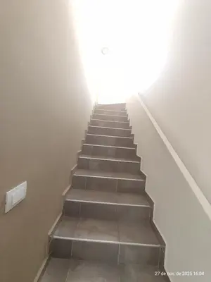 a staircase in a building with a light at the top at Cuesta Blanca dos dormitorios cochera in Cuesta Blanca