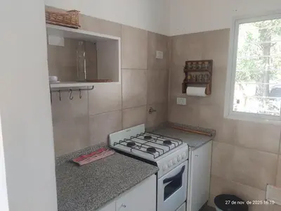a kitchen with a stove and a counter top at Cuesta Blanca dos dormitorios cochera in Cuesta Blanca