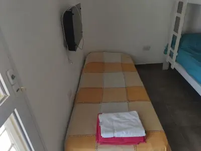 a small room with two bunk beds in it at Cuesta Blanca dos dormitorios cochera in Cuesta Blanca
