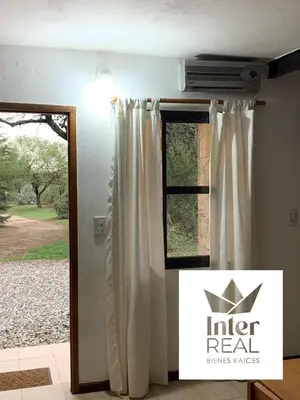 a room with a door and a window with curtains at cabañas Gerom in Merlo