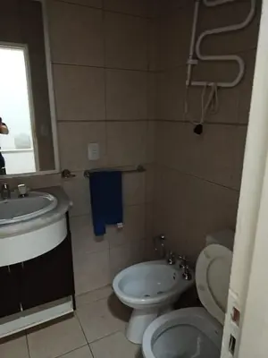 a bathroom with a toilet and a sink at Complejo NOVIEMBRE in Cordoba
