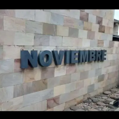 a sign on the side of a building with the words novoeper at Complejo NOVIEMBRE in Cordoba