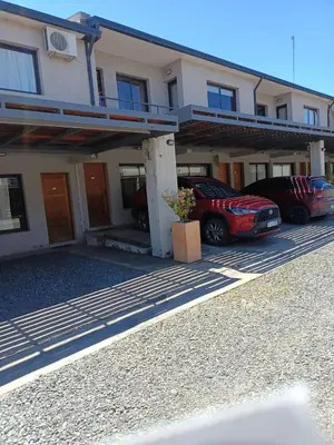 two cars parked in a parking lot in front of a building at Complejo NOVIEMBRE in Cordoba