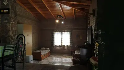 a living room with a bed and a window at Casa Villa Carlos paz in Villa Carlos Paz