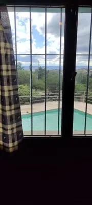 a view of a swimming pool from a window at Casa Villa Carlos paz in Villa Carlos Paz